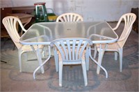 Glass Top Patio Table with 4 Plastic Chairs -
