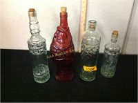 3 clear glass bottles and 1 red fish bottle