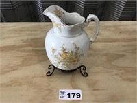 PORCELAIN PITCHER ON METAL STAND