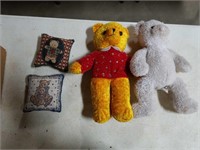 2 stuffed bears and pillows