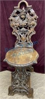 Heavily carved German parlor chair with winged