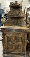 Heavily carved German oak corner cabinet