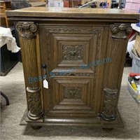 Heavily carved cabinet with fluted columns