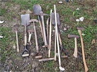 lot of tools- shovel, axe, hoe, etc.