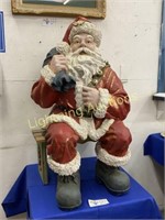 SEATED SANTA CLAUS WITH BAG OF GIFTS IN RESIN