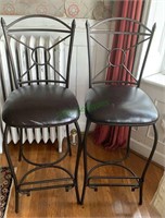 2 tall barstools with a flip down bottom foot