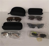 Four pairs of sunglasses new in packages or cases