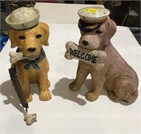2 composite dog statues, one damaged