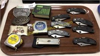 Collection of pocket knives, tape measures, belt