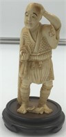 Ivory carving of a man shielding his eyes from the