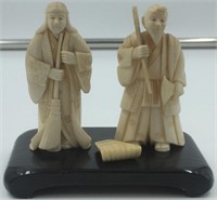 Lot of 2 ivory carvings:  man holding a broom, and