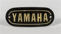 YAMAHA: A black and gold 'YAMAHA' badge