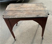 Metal table on wheels with wood top