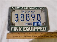 Motorcycle license plate with metal frame.