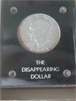 " The Disappearing Dollar " paperweight.