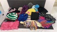 Two boxes of kids sized toques and scarfs.