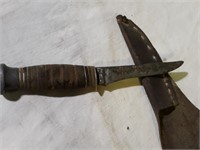 Remington knife in leather sheath.