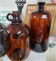 2 large brown glass containers.