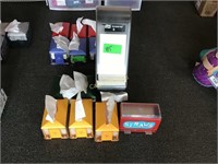 Six napkin dispensers and a straw dispenser