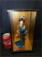 Oriental doll in display case