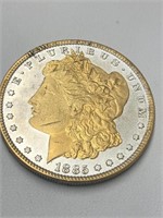1885 Morgan silver dollar with gold tint