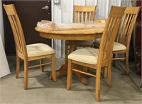 Round wooden table with four chairs measures 44”
