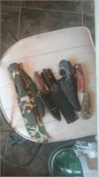 Group of many hunting knives some in camouflage