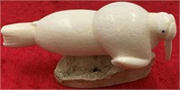 J Wongittilin ivory carving of a walrus on fossili