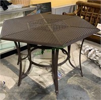 Large cast aluminum tall patio table with a