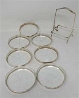 Group of sterling rimmed coasters and holder