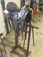Antique saddle, stirrups and bit. Saddle stand