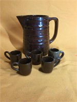 Stoneware pitcher and five mini mugs