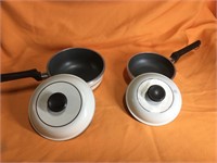 Two heavy sauce pans (7” & 8”) with lids