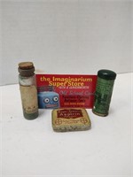 Two small tins and a small corked vial.