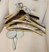 lot of coat hangers and hang mirrors