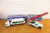 Two toy trucks with boxes