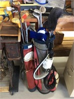 Pair of golf bags with clubs