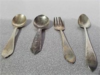 Four children's spoons and forks all marked