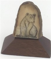 Scrimshaw of a bear by Michael Scott on fossilized
