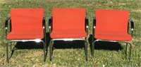Orange mid century style arm chairs