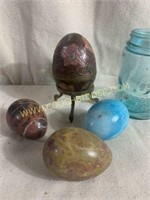 Carved stone eggs and Brass egg on stand
