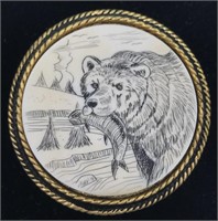 Scrimshawed ivory platchet of a bear with his supp