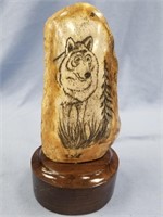 Scrimshaw of a wolf by Michael Scott on fossilized