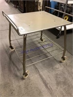 Small metal TV stand on wheels