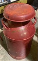 Large metal milk jug about 20 to 25 gallons with