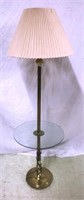 Brass floor lamp with glass table surface