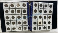 Foreign coin collection organized in a notebook