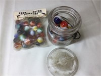 Small glass jar with lid and marbles