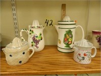 (4) Decorated Juicer Pitchers (1 has small chip)