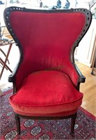 Antique queen wing back chair upholstered in a